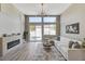 Bright living room features modern fireplace, recessed lighting, and sliding glass doors to backyard pool at 2714 Langlade Ave, Henderson, NV 89052