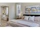 Inviting primary bedroom with a view of the ensuite bathroom, with a comfortable bed and stylish decor at 2714 Langlade Ave, Henderson, NV 89052