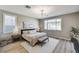 Calm primary bedroom featuring two windows, a comfortable bed, and coordinated furniture and decor at 2714 Langlade Ave, Henderson, NV 89052