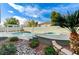 Backyard oasis with a refreshing pool, jacuzzi, well-manicured landscape, and desert flora at 2714 Langlade Ave, Henderson, NV 89052