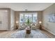 Bright sitting area featuring a bay window, two white armchairs, stylish rug, and side tables with lamps at 2714 Langlade Ave, Henderson, NV 89052