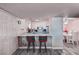 Kitchen boasts white cabinets and appliances, breakfast bar and dining area with pink accent wall at 2725 S Nellis Blvd # 1038, Las Vegas, NV 89121