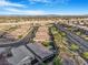 Scenic aerial shot of a neighborhood, highlighting well-maintained homes with desert landscaping and community walking paths at 2771 Free Formed Ct, Las Vegas, NV 89138