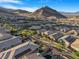 Picturesque aerial perspective of a suburban neighborhood, featuring homes with solar panels set against a mountain backdrop at 2771 Free Formed Ct, Las Vegas, NV 89138