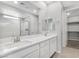 Modern bathroom with double sinks, large mirror, and a glass-enclosed shower at 2771 Free Formed Ct, Las Vegas, NV 89138