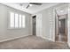 Neutral bedroom with a closet, carpet, ceiling fan, and shutters at 2771 Free Formed Ct, Las Vegas, NV 89138