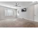 Spacious bedroom featuring carpeted floors, a ceiling fan, and a wall-mounted television at 2771 Free Formed Ct, Las Vegas, NV 89138