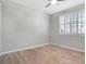 Bright bedroom features a modern ceiling fan, shutters, and wood-look tile flooring at 2771 Free Formed Ct, Las Vegas, NV 89138