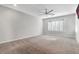 Large bedroom with carpeted floors, a ceiling fan, and plantation shutters at 2771 Free Formed Ct, Las Vegas, NV 89138