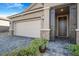 Front exterior showcasing the garage, entry door, stone accents, and paver driveway at 2771 Free Formed Ct, Las Vegas, NV 89138