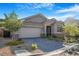 Exterior shot of a well maintained home featuring landscaping, and a paver driveway at 2771 Free Formed Ct, Las Vegas, NV 89138
