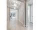 Hallway with modern lighting leading to a living room with large windows, and an adjacent bedroom at 2771 Free Formed Ct, Las Vegas, NV 89138