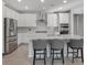 Modern kitchen with stainless steel appliances, a breakfast bar, and stylish gray bar stools at 2771 Free Formed Ct, Las Vegas, NV 89138