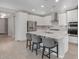 Sleek kitchen featuring white cabinetry, stainless steel appliances, and a center island with seating at 2771 Free Formed Ct, Las Vegas, NV 89138