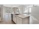 Open kitchen layout with island seating, seamlessly flowing into the adjacent living area at 2771 Free Formed Ct, Las Vegas, NV 89138