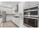 Close-up of modern kitchen with stainless steel appliances and white cabinets at 2771 Free Formed Ct, Las Vegas, NV 89138