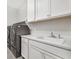 Laundry room with a sink, quartz countertops, and modern washer and dryer at 2771 Free Formed Ct, Las Vegas, NV 89138