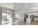 Open-concept living space with chandelier lighting, tile floors, and sliding glass doors to the outside at 2771 Free Formed Ct, Las Vegas, NV 89138