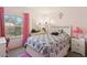Pink bedroom featuring a large window, a bed with patterned bedding, and coordinated decor at 2830 Crystal Lantern Dr, Henderson, NV 89074