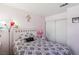 Pink bedroom with patterned bedding, a nightstand, and closet doors at 2830 Crystal Lantern Dr, Henderson, NV 89074