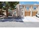 Charming townhome featuring a two-car garage and desert landscaping with mature trees at 2830 Crystal Lantern Dr, Henderson, NV 89074