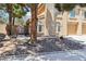 Front yard featuring desert landscaping, mature trees, and an inviting walkway to the entrance at 2830 Crystal Lantern Dr, Henderson, NV 89074