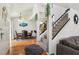Open-concept living room with hardwood floors, staircase, dining area and natural light at 2830 Crystal Lantern Dr, Henderson, NV 89074