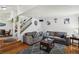 Bright living room featuring comfortable sofas, staircase, and open layout at 2830 Crystal Lantern Dr, Henderson, NV 89074