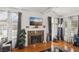 Bright living room with hardwood floors, decorative fireplace, and abundant natural light at 2830 Crystal Lantern Dr, Henderson, NV 89074