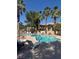 Community pool with lounge chairs and tropical palm tree landscaping at 2830 Crystal Lantern Dr, Henderson, NV 89074