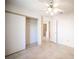 Bedroom with tiled floor, closet with white sliding doors, light walls, and ceiling fan at 2859 Palleta Dr, Henderson, NV 89074
