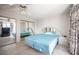 This bedroom has tile floors, a ceiling fan, mirrored sliding door closets and a large bed at 2859 Palleta Dr, Henderson, NV 89074