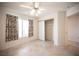 Bedroom with tiled floor, light walls, closet, ceiling fan and a window with patterned curtains at 2859 Palleta Dr, Henderson, NV 89074