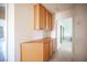 Hallway with tile flooring, light walls, and built-in wood cabinets at 2859 Palleta Dr, Henderson, NV 89074