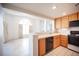 Bright kitchen with tile floors, wood cabinets, black appliances, and lots of natural light at 2859 Palleta Dr, Henderson, NV 89074