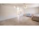 Spacious living room with tile floors, neutral walls, and an open layout that flows into other areas of the home at 2859 Palleta Dr, Henderson, NV 89074
