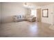 Bright living room with tile flooring, a comfortable sofa, and ample natural light from the large window at 2859 Palleta Dr, Henderson, NV 89074