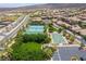 Aerial perspective of community amenities with tennis courts, a basketball court, and lush green spaces at 2896 Grande Arch St, Henderson, NV 89044