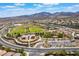 Beautiful aerial view of a Primary-planned community with green spaces, walking paths, and mountain views at 2896 Grande Arch St, Henderson, NV 89044