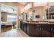 Spacious bathroom with dual sinks, dark wood cabinets, and access to the bedroom and shower at 2896 Grande Arch St, Henderson, NV 89044