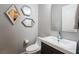 Modern half-bathroom with geometric mirrors and sleek fixtures at 2896 Grande Arch St, Henderson, NV 89044