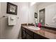 Bathroom featuring a framed print, single sink vanity and dark wood cabinets at 2896 Grande Arch St, Henderson, NV 89044