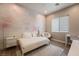 Cozy bedroom with decorative wallpaper, a large window and modern decor at 2896 Grande Arch St, Henderson, NV 89044