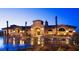 Stunning community clubhouse with stone accents, arched entryway, and well-lit exterior at 2896 Grande Arch St, Henderson, NV 89044