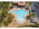 Overhead shot of a resort-style community pool with lush landscaping, lounging areas, and shade structures at 2896 Grande Arch St, Henderson, NV 89044