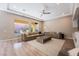 Spacious living room with large windows, hardwood floors, and contemporary furnishings at 2896 Grande Arch St, Henderson, NV 89044