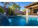 Backyard pool with water feature and well-maintained landscaping at 2896 Grande Arch St, Henderson, NV 89044