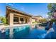 Backyard pool with covered patio area, outdoor furniture and well-maintained landscaping at 2896 Grande Arch St, Henderson, NV 89044