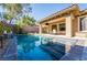 Sparkling pool with water feature and covered patio area at 2896 Grande Arch St, Henderson, NV 89044