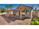 Inviting backyard featuring a covered patio, desert landscaping, and mature palm trees at 2904 Channel Bay Dr, Las Vegas, NV 89128